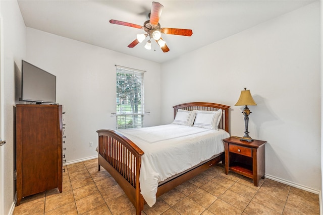 tiled bedroom featuring ceiling fan