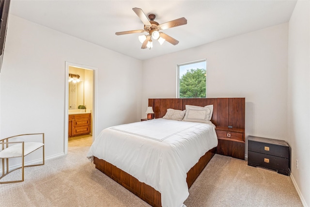 carpeted bedroom with ceiling fan and ensuite bathroom