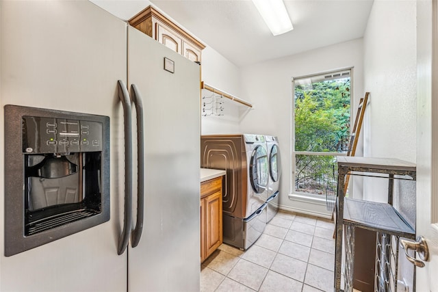 washroom with cabinets, light tile patterned floors, and separate washer and dryer