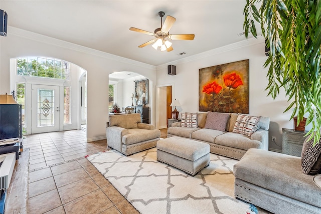 living room featuring light tile patterned floors, ceiling fan, and ornamental molding