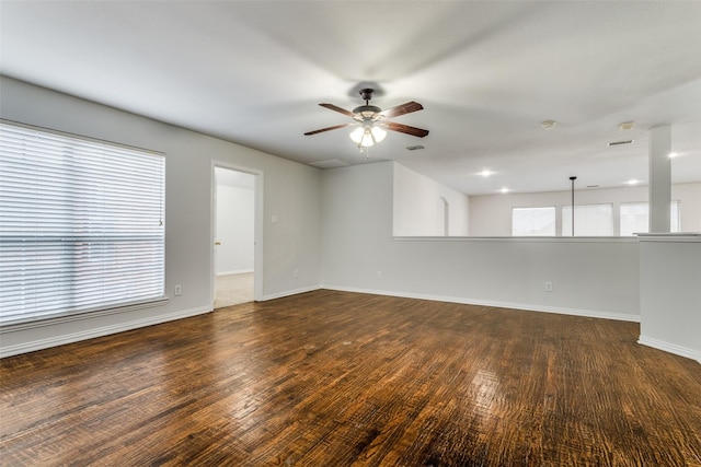 spare room featuring dark wood-type flooring and ceiling fan