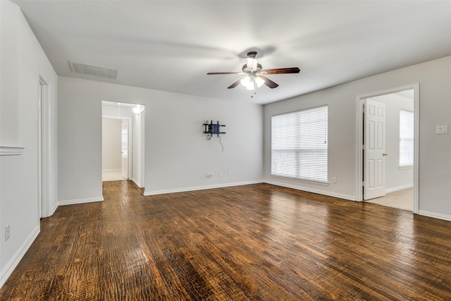 interior space featuring dark wood-type flooring and ceiling fan