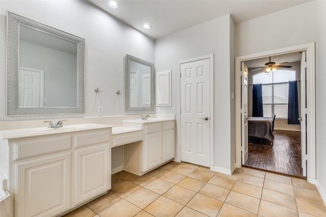 bathroom featuring tile patterned flooring, vanity, and ceiling fan