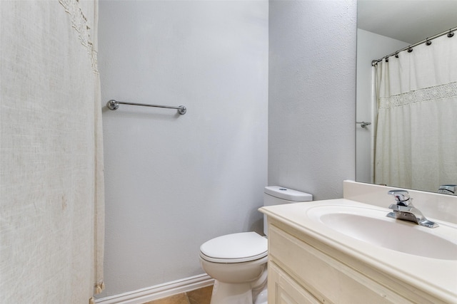 bathroom with vanity, tile patterned floors, and toilet