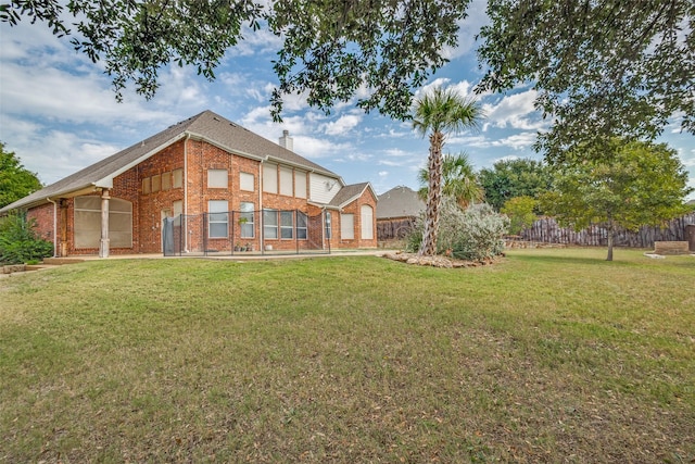 rear view of house featuring a lawn