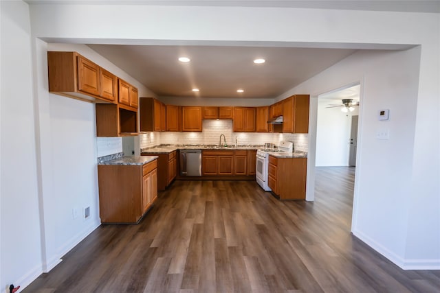 kitchen with light stone countertops, sink, stainless steel dishwasher, dark hardwood / wood-style floors, and white stove