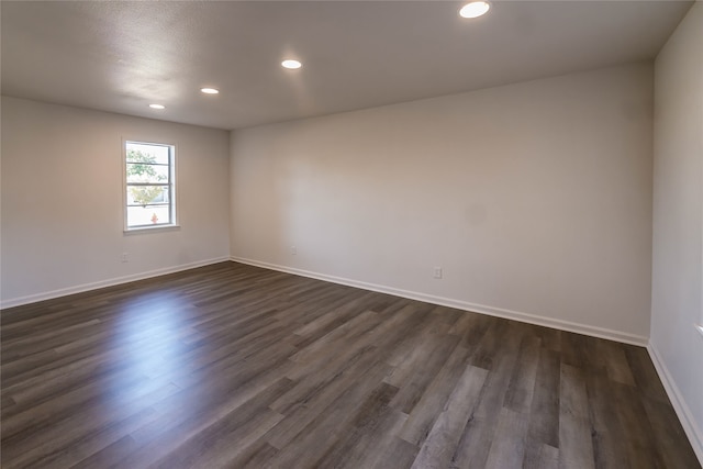 unfurnished room with dark hardwood / wood-style floors