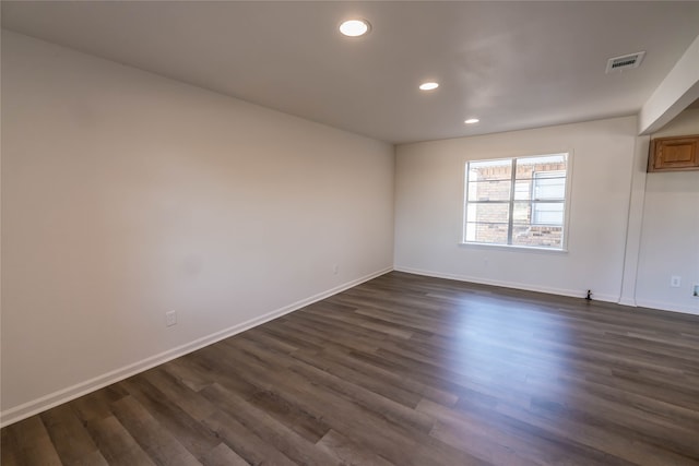 empty room featuring dark wood-type flooring