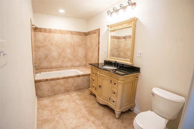 full bathroom with vanity, tiled shower / bath combo, and toilet