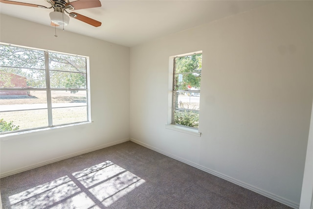 empty room with ceiling fan and carpet floors