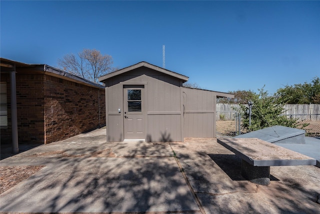 view of side of property featuring a shed