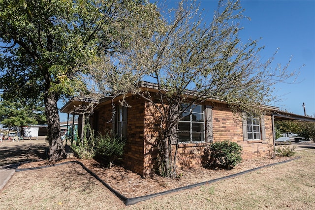 view of side of home with a carport