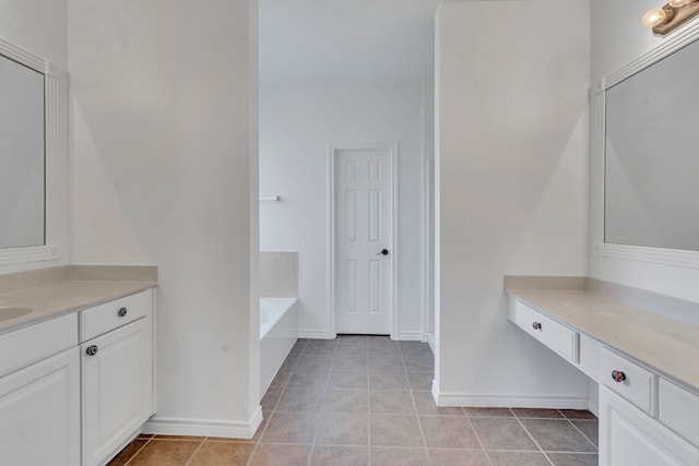 interior space with vanity, tile patterned floors, and a washtub