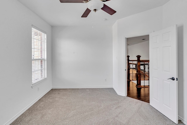 carpeted empty room featuring lofted ceiling and ceiling fan