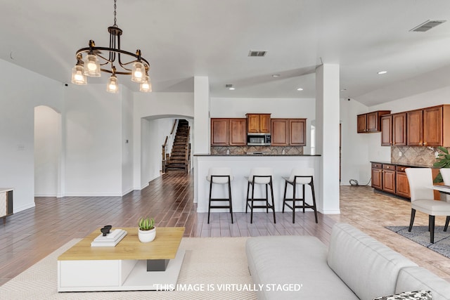 living room with an inviting chandelier and hardwood / wood-style floors