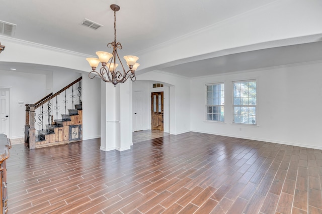 interior space featuring ornamental molding, a notable chandelier, and wood-type flooring