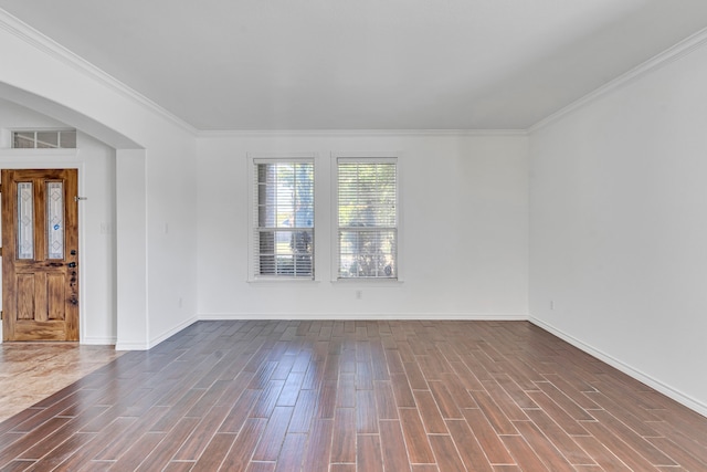 empty room featuring crown molding and dark hardwood / wood-style flooring