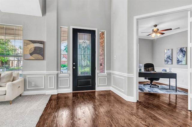 entrance foyer featuring a wealth of natural light, wood-type flooring, ceiling fan, and crown molding