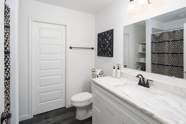 full bath with toilet, curtained shower, vanity, and wood finished floors