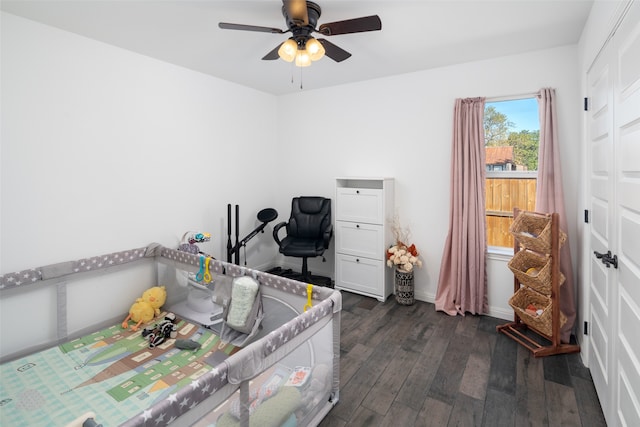 bedroom featuring ceiling fan, baseboards, and dark wood finished floors