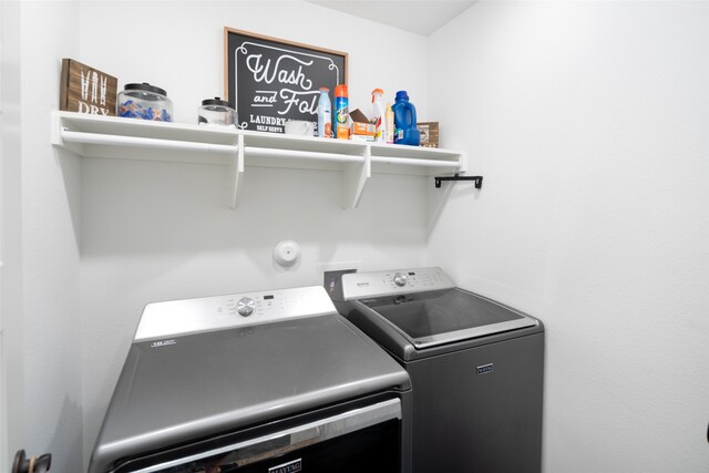 laundry room featuring separate washer and dryer and laundry area