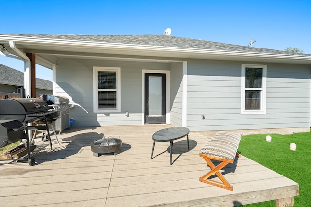 deck with an outdoor fire pit and grilling area