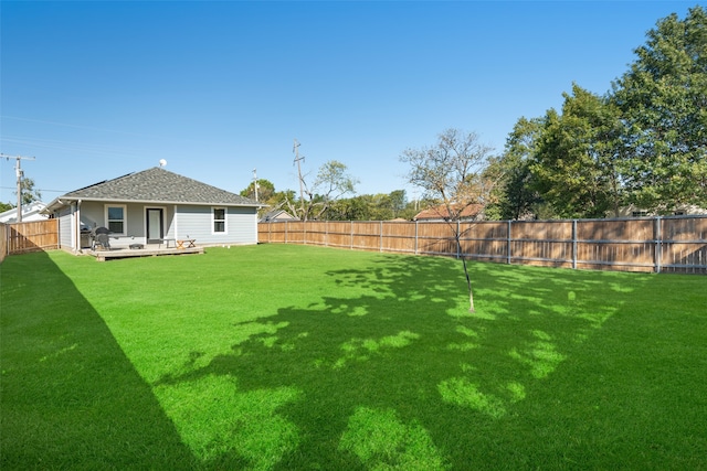 view of yard featuring a wooden deck and a fenced backyard