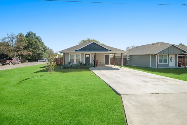 ranch-style home featuring a front lawn, concrete driveway, board and batten siding, and an attached carport