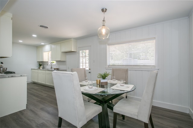 dining area featuring sink and dark hardwood / wood-style floors