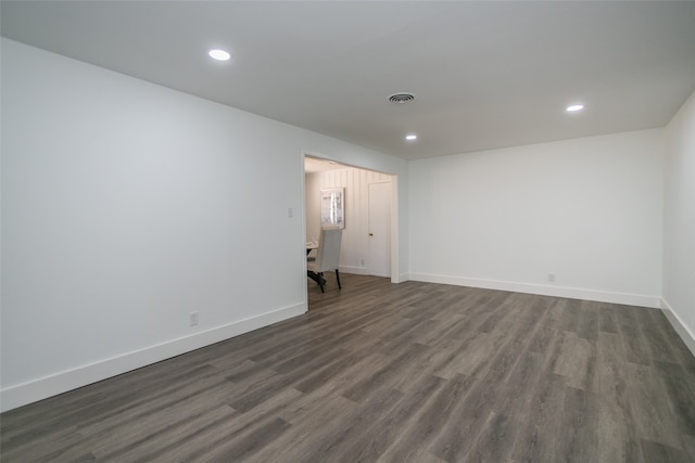 spare room featuring dark wood-type flooring