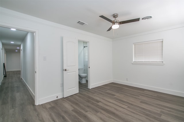 unfurnished bedroom with connected bathroom, ceiling fan, crown molding, and dark hardwood / wood-style floors