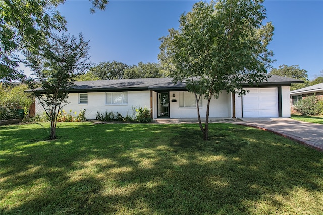 single story home featuring a front lawn and a garage