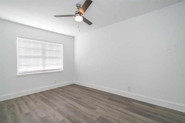 empty room with dark hardwood / wood-style floors and ceiling fan