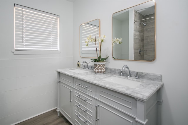 bathroom featuring vanity, hardwood / wood-style flooring, and a shower