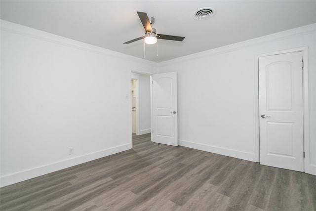 unfurnished room featuring crown molding, ceiling fan, and dark hardwood / wood-style flooring