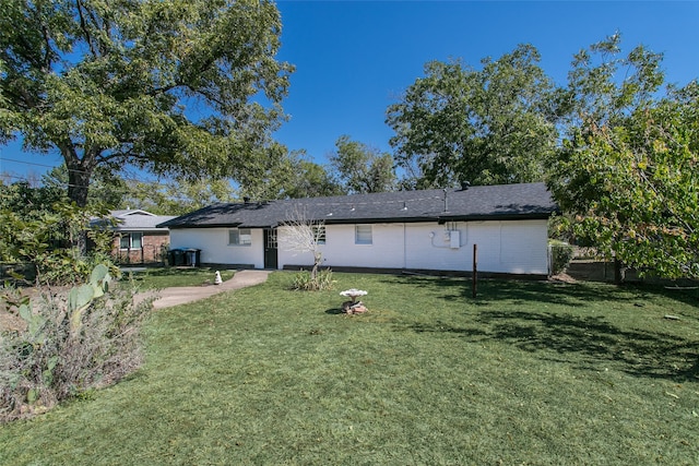 rear view of property with a yard