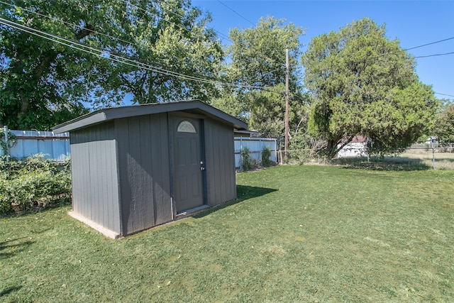 view of outdoor structure featuring a lawn