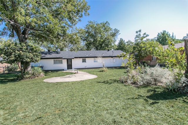 back of property featuring a yard and a patio