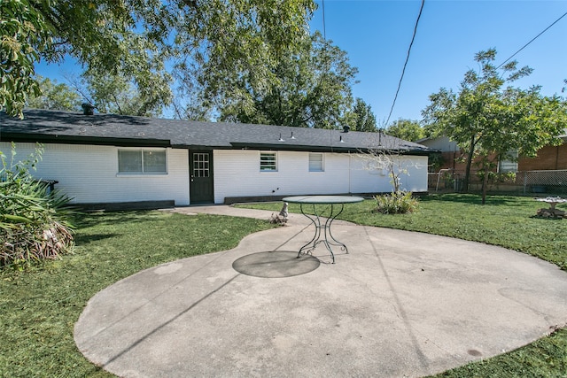 back of house featuring a patio area and a yard