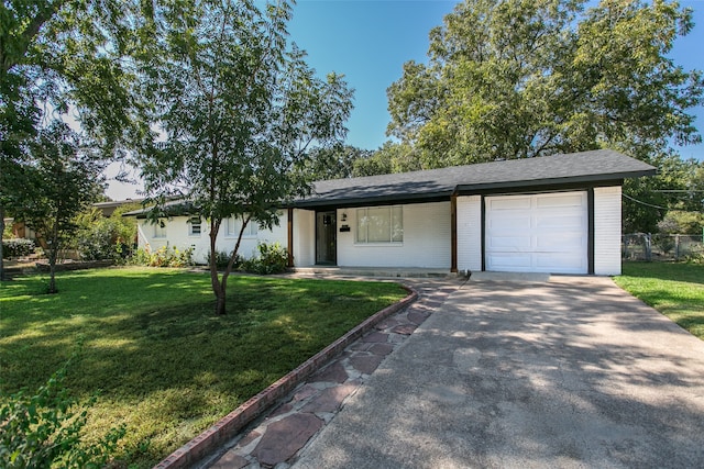 single story home with a front yard and a garage