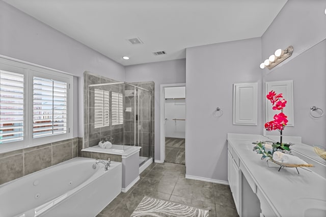 bathroom featuring tile patterned flooring, vanity, and separate shower and tub