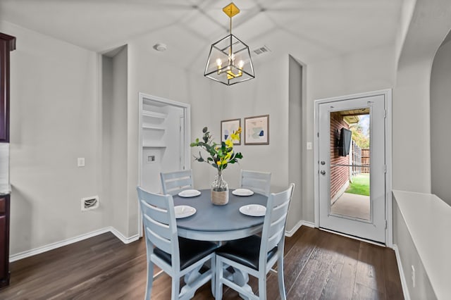 dining space featuring an inviting chandelier and dark wood-type flooring