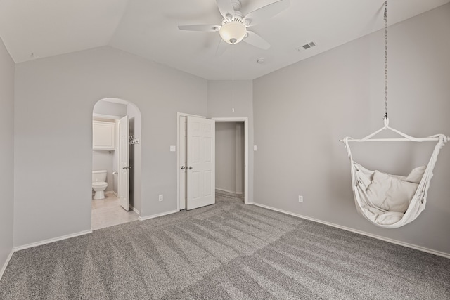 unfurnished bedroom featuring ceiling fan, lofted ceiling, and light carpet