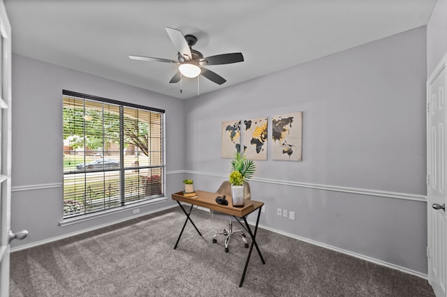 carpeted office space featuring ceiling fan