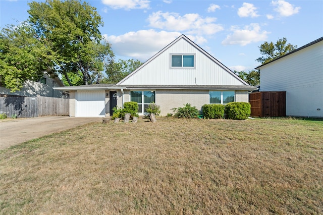 view of front of home with a front lawn and a garage