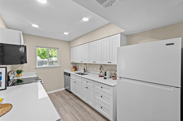 kitchen with white cabinetry, light hardwood / wood-style flooring, dishwasher, and white fridge