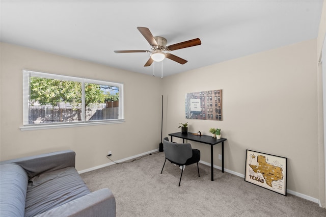 home office featuring light carpet and ceiling fan