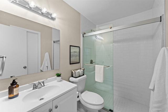 bathroom with a shower with door, toilet, and vanity