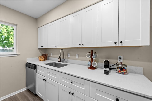 kitchen featuring dishwasher and white cabinets