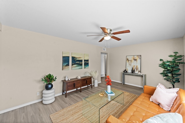 living room with ceiling fan and hardwood / wood-style flooring